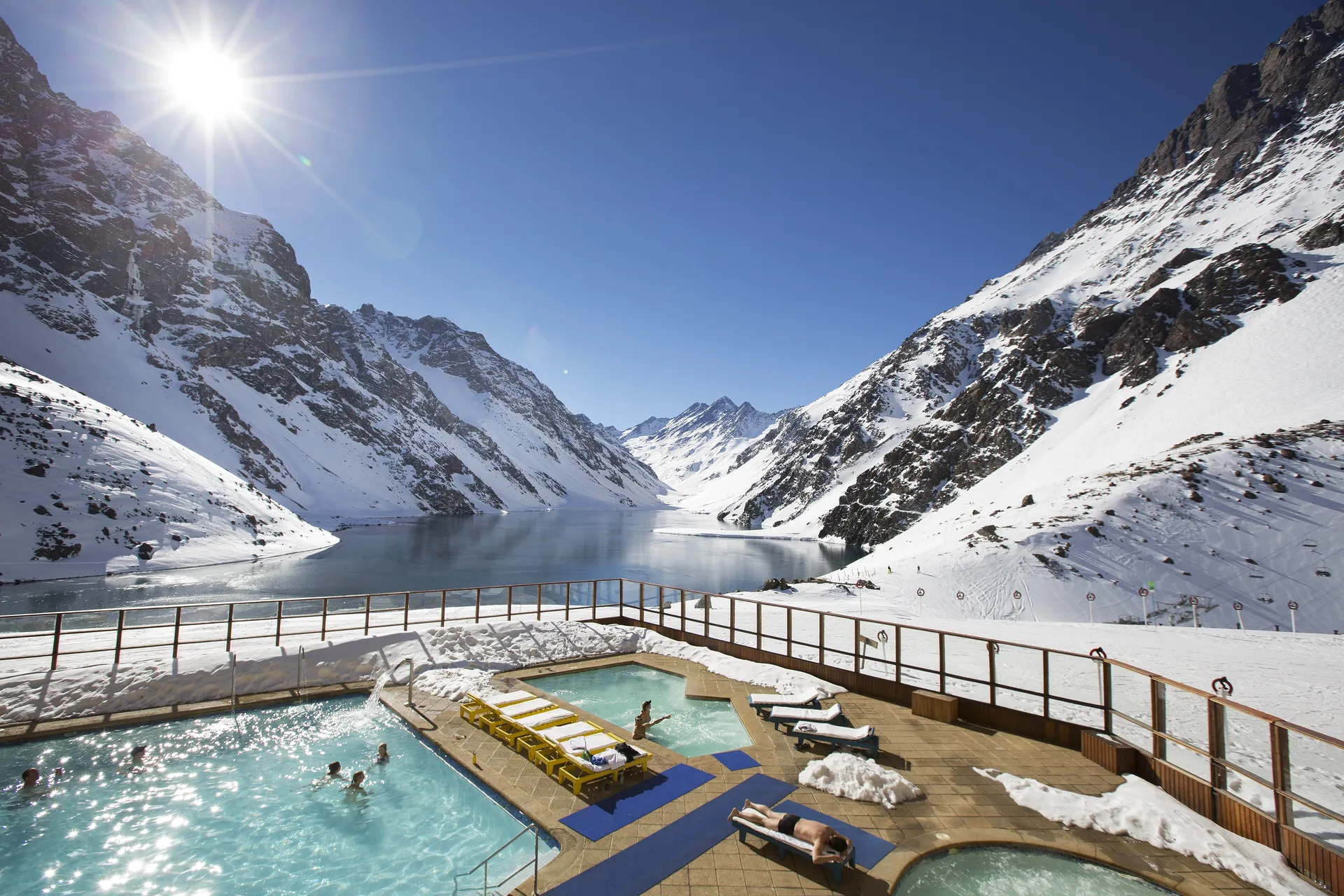Sun-drenched pool deck with frozen lake