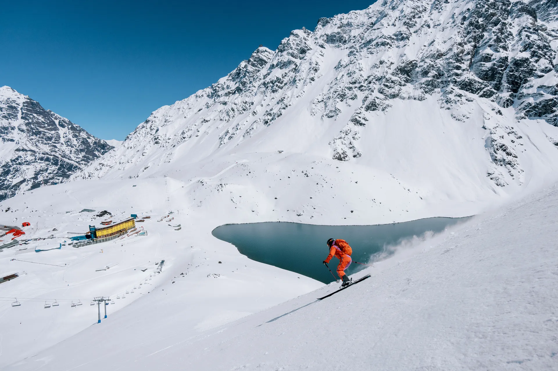 Skier with lake and yellow hotel